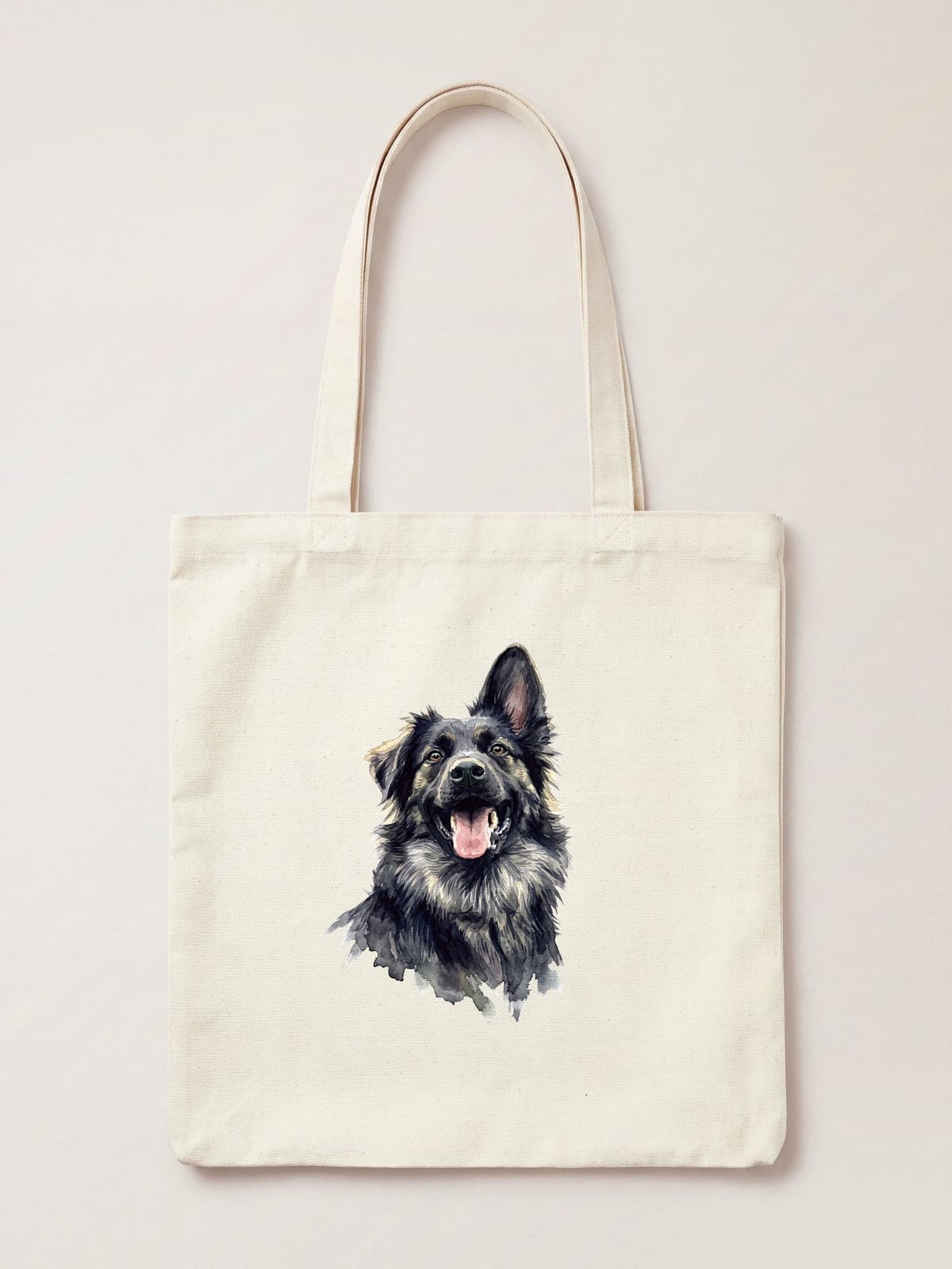 A watercolour portrait of a black and tan shepherd dog printed on a natural cotton tote bag